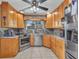 Well-lit kitchen with wood cabinetry, stainless steel appliances, and granite countertops at 4178 Rose Arbor Cir, Port Charlotte, FL 33948