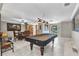 Spacious living room with pool table, dining area, and views of the backyard at 4178 Rose Arbor Cir, Port Charlotte, FL 33948