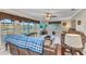 Comfortable living room with large windows, a ceiling fan, and cozy furniture at 4178 Rose Arbor Cir, Port Charlotte, FL 33948