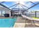 Enjoy the outdoor living space with a screened lanai and refreshing pool overlooking the backyard at 4178 Rose Arbor Cir, Port Charlotte, FL 33948