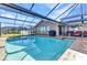 The backyard pool with a screened in lanai with nice patio furniture to enjoy outdoor living at 4178 Rose Arbor Cir, Port Charlotte, FL 33948