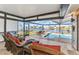 Outdoor living space showcasing screened-in lanai, pool, comfortable seating, and scenic canal view at 4178 Rose Arbor Cir, Port Charlotte, FL 33948