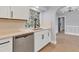 Modern kitchen with stainless steel appliances, white cabinets, and quartz countertops at 4290 Yucatan Cir, Port Charlotte, FL 33948