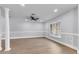 Spacious living room with neutral paint, a ceiling fan, and light wood-look flooring at 4290 Yucatan Cir, Port Charlotte, FL 33948