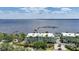 Scenic aerial view showcasing waterfront condos with a charming pier and marina against the open water at 5114 Melbourne St # A202, Punta Gorda, FL 33980