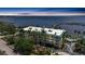 Stunning aerial shot of waterfront condo complex with lush landscaping, private pier, and serene water views at 5114 Melbourne St # A202, Punta Gorda, FL 33980