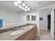 Bathroom showcasing a granite countertop vanity, modern mirror, and tiled floors at 5114 Melbourne St # A202, Punta Gorda, FL 33980