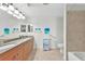 Bathroom with double sinks, granite countertops, and a tiled shower/tub combination at 5114 Melbourne St # A202, Punta Gorda, FL 33980