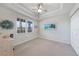 Bedroom with tray ceiling, light-colored walls, and large window with a view at 5114 Melbourne St # A202, Punta Gorda, FL 33980