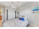 Bright bedroom with a sliding door closet, marine decor, and view of the hall at 5114 Melbourne St # A202, Punta Gorda, FL 33980