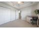 Bedroom featuring a large closet, neutral carpet, desk, and ceiling fan at 5114 Melbourne St # A202, Punta Gorda, FL 33980