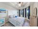 Cozy bedroom with marine decor, a ceiling fan, and windows letting in natural light at 5114 Melbourne St # A202, Punta Gorda, FL 33980