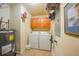Laundry room with appliances, storage cabinets, and water heater at 5114 Melbourne St # A202, Punta Gorda, FL 33980