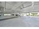 Wide angle view of parking garage with multiple cars parked inside and parking spots throughout at 5114 Melbourne St # A202, Punta Gorda, FL 33980
