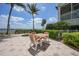 Charming outdoor patio with table and chairs, surrounded by lush plants and a view of the water at 5114 Melbourne St # A202, Punta Gorda, FL 33980