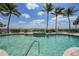 Relaxing community pool with palm trees and waterfront views in a serene setting at 5114 Melbourne St # A202, Punta Gorda, FL 33980