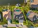 Aerial view of a beautiful home with a pool, boat dock, and waterfront access at 529 La Caruna Ct, Punta Gorda, FL 33950