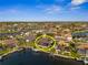 Waterfront home with private dock and screened lanai with pool, surrounded by lush landscaping and beautiful blue water views at 529 La Caruna Ct, Punta Gorda, FL 33950