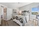 Bedroom with a ceiling fan, neutral walls, wood floors, and scenic views from the window at 529 La Caruna Ct, Punta Gorda, FL 33950