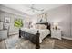 Bright bedroom with a ceiling fan, neutral walls, and a dark-colored bed frame at 529 La Caruna Ct, Punta Gorda, FL 33950