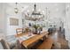 Open dining area featuring wood table and bench with chandelier and views of the living room and kitchen at 529 La Caruna Ct, Punta Gorda, FL 33950