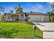 Well-manicured lawn and lush landscaping surround this beautiful single-story home with a three-car garage at 529 La Caruna Ct, Punta Gorda, FL 33950
