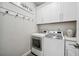 Laundry room featuring modern washer and dryer and cabinet storage at 529 La Caruna Ct, Punta Gorda, FL 33950