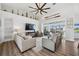 Comfortable living room featuring a vaulted ceiling, white shiplap wall, ceiling fan, and wood-look flooring at 529 La Caruna Ct, Punta Gorda, FL 33950