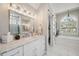 Bright main bathroom with white marble floors, vanity, and barn door to toilet at 529 La Caruna Ct, Punta Gorda, FL 33950