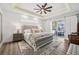 Main bedroom with wood accent wall, ceiling fan, and sliding glass doors to the backyard at 529 La Caruna Ct, Punta Gorda, FL 33950