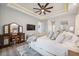 Bright main bedroom featuring a tray ceiling, ceiling fan, and vanity area at 529 La Caruna Ct, Punta Gorda, FL 33950
