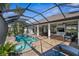 Beautiful pool and patio with a screened enclosure, comfortable seating, and lush greenery at 529 La Caruna Ct, Punta Gorda, FL 33950