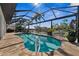 Screened in kidney-shaped pool overlooking a waterway and lush landscaping at 529 La Caruna Ct, Punta Gorda, FL 33950