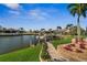 Scenic waterfront view with lush landscaping, a boat lift, and a serene atmosphere at 529 La Caruna Ct, Punta Gorda, FL 33950