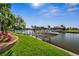 Picturesque waterfront with a boat lift, vibrant landscaping, and tranquil surroundings at 529 La Caruna Ct, Punta Gorda, FL 33950