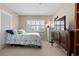 Bright bedroom featuring neutral walls, a window with blinds, and a dresser with a mounted television at 5390 Brassy Loop, North Port, FL 34287