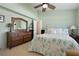 Bedroom with stylish dresser, coastal accents, comfortable bedding and ensuite at 5390 Brassy Loop, North Port, FL 34287