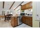 Efficient kitchen layout featuring a bar and seamless connection to the dining area at 5390 Brassy Loop, North Port, FL 34287