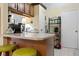 Kitchen bar area with green bar stools and views of the living area at 5390 Brassy Loop, North Port, FL 34287