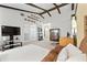 Open-concept living room with exposed beams and views of the front entry and dining area at 5390 Brassy Loop, North Port, FL 34287