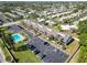 A high-angle photo of condos, parking, and landscaping, in a well-maintained community with a pool at 5416 Swift Rd # 27, Sarasota, FL 34231