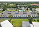 A sunlit aerial view of condominiums with pool, green lawn and palms at 5416 Swift Rd # 27, Sarasota, FL 34231
