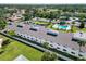 Aerial view of a condo complex with a community pool, parking, and an enclosed yard at 5416 Swift Rd # 27, Sarasota, FL 34231