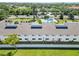 Aerial view features white condominiums, a community pool, ample parking, and well-maintained green spaces at 5416 Swift Rd # 27, Sarasota, FL 34231