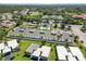 Aerial view of white condominiums with community pool, and lush landscaping near a roadway at 5416 Swift Rd # 27, Sarasota, FL 34231