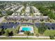 Aerial view of condo community with a swimming pool, parking and mature trees at 5416 Swift Rd # 27, Sarasota, FL 34231