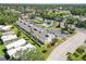 Aerial view of condo complex with a community pool, parking, and beautiful landscaping at 5416 Swift Rd # 27, Sarasota, FL 34231