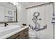 Clean bathroom features a stylish vanity, sink and an anchor-themed shower curtain at 5416 Swift Rd # 27, Sarasota, FL 34231
