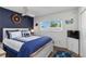 Bedroom with nautical decor, ceiling fan, window, hardwood floors, and television at 5416 Swift Rd # 27, Sarasota, FL 34231