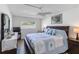 Bright bedroom with nautical bedding, wood floors, ceiling fan, and nightstands at 5416 Swift Rd # 27, Sarasota, FL 34231